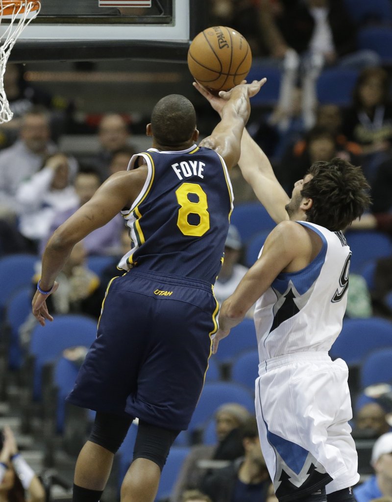 Utah’s Randy Foye tries to block a layup by Minnesota’s Ricky Rubio in the first quarter of a 96-80 win by the Jazz at Minneapolis on Monday. The win was a critical one for Utah, which is trying to avoid elimination from the playoffs.