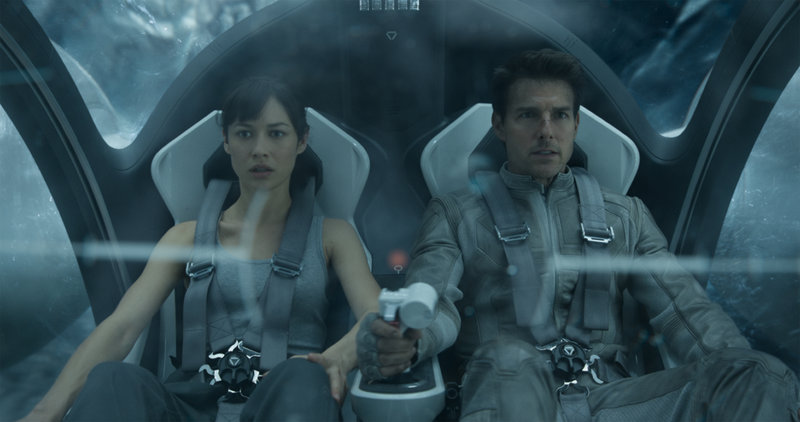 Olga Kurylenko, left, plays an astronaut who may have a past with Jack Harper, played by Tom Cruise, in “Oblivion.”