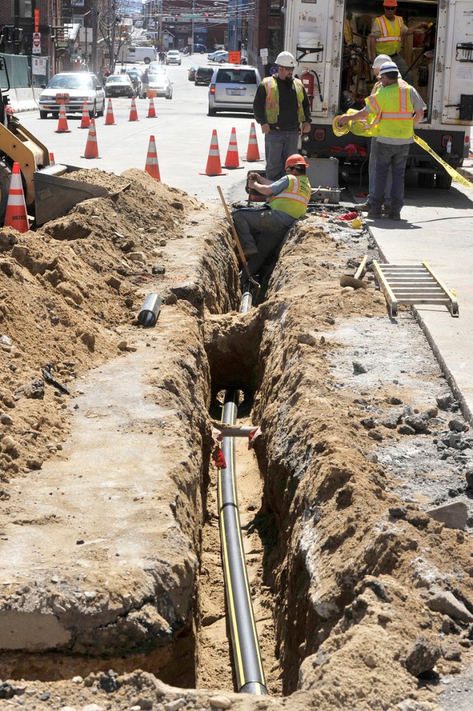 In this Wednesday, April 17 photo, crews install new natural gas lines in Portland's Old Port district on Temple Street. Unitil says it needs to raise prices to offset rising construction costs and other expenses related to distribution.