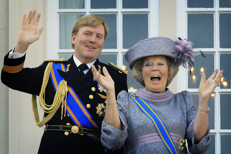 Queen Beatrix and Crown Prince Willem-Alexander wave to well-wishers from the balcony of Royal Palace in The Hague, Netherlands, in 2010.