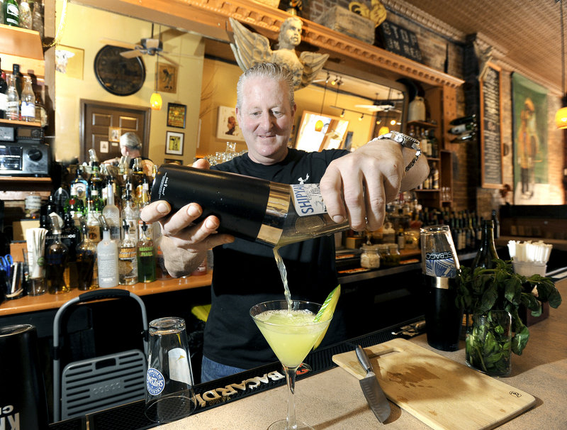 Co-owner and bartender Noah Talmatch pours a cucumber gin martini at The North Point.