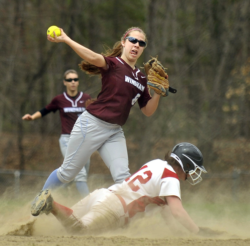 Madison Elliott of Windham attempts to turn a double play Friday as Jen Jones of Sanford slides into second base during their SMAA softball opener. Windham came away with a 5-0 victory.