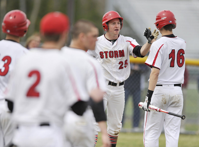 Ben Greenberg of Scarborough is greeted by teammates, including Trevor Sparda, right, after scoring in the sixth inning Friday, the final run in a 3-0 victory against Thornton Academy. Greenberg also pitched a two-hitter with eight strikeouts.