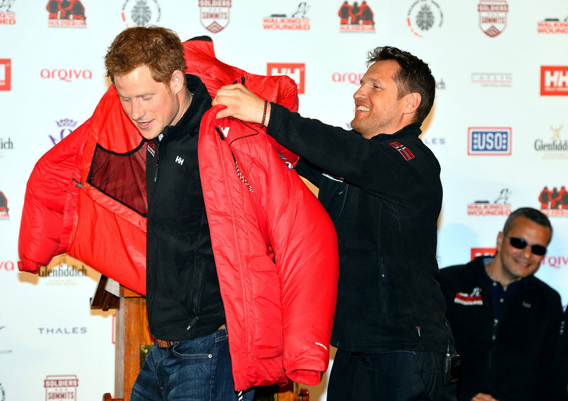 Prince Harry is presented a red thermal coat Friday during the launch of the Walking With The Wounded South Pole Allied Challenge 2013.