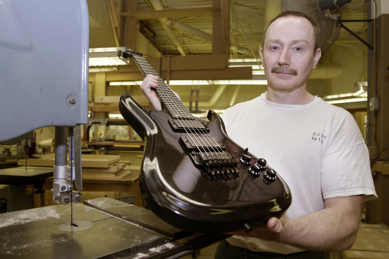Allen Eason poses with a guitar he made. Eason is a master furniture maker and a convicted murderer without the possibility of parole. “This is my life,” Eason said.