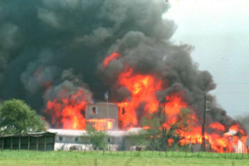 Fire engulfs the Branch Davidian compound near Waco, Texas, in this April 19, 1993, file photo. Some who survived the end to the 51-day standoff had a memorial service Friday.