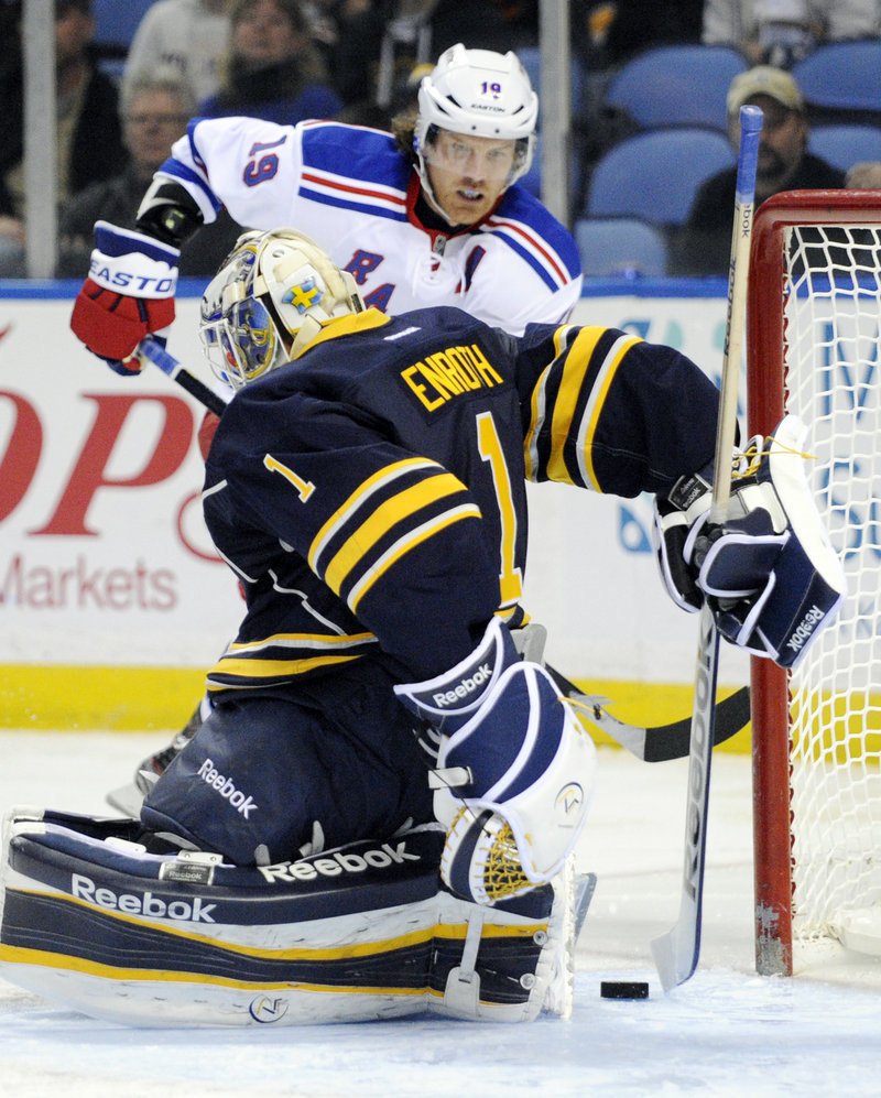 New York forward Brad Richards gets ready to poke a loose puck past Buffalo goaltender Jhonas Enroth during second-period action of Friday’s rout of the hapless Sabres. Richards scored three goals as the Rangers took undisputed possession of eighth place in the East with just four games left in the regular season.
