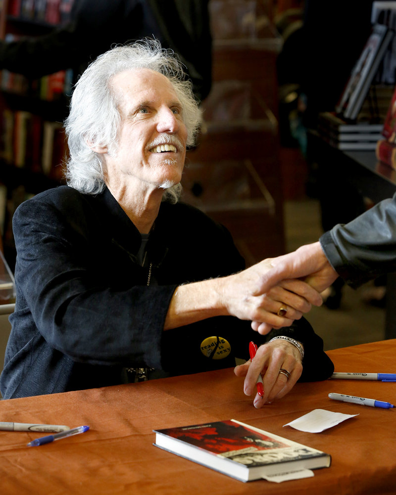John Densmore greets a fan while signing copies of his book, “The Doors Unhinged,” at Bull Moose in Scarborough on Saturday.
