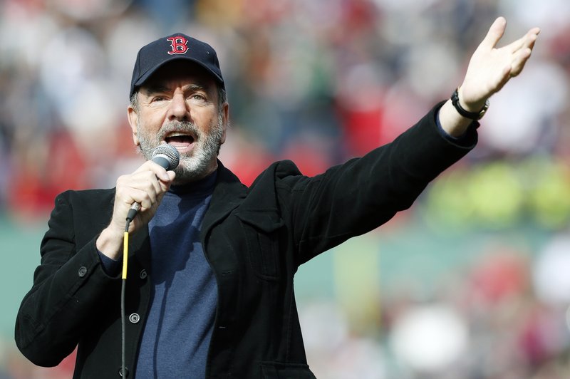 Neil Diamond wows the crowd by singing “Sweet Caroline” in the eighth inning of the game. The singer asked to perform after traveling to the game on his own initiative.