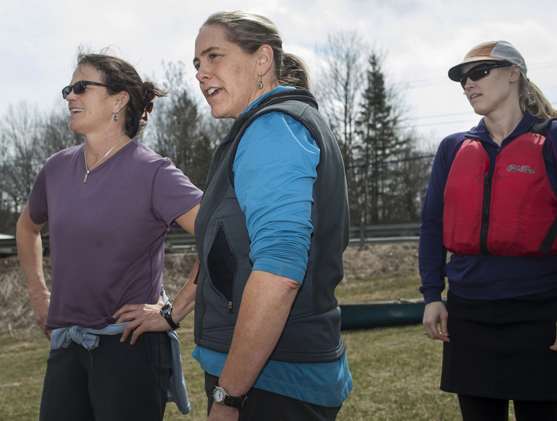 Tammy Kelley, center, and crew mates Ander Thibaud, left, and Leslie Winchester try to figure out the best course to take through obstacles on the low-water Kenduskeag Stream.