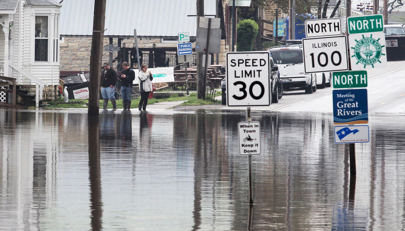 Water covers the intersection of routes 100 and 3 in Grafton, Ill. on Tuesday. Floodwaters were rising to record levels along the Illinois River in central Illinois.