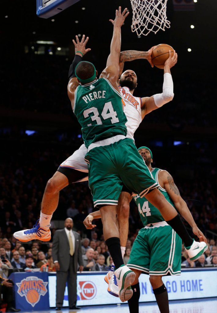 Paul Pierce of the Boston Celtics tries to prevent Tyson Chandler of the New York Knicks from getting to the basket Tuesday night during New York’s 87-71 victory.