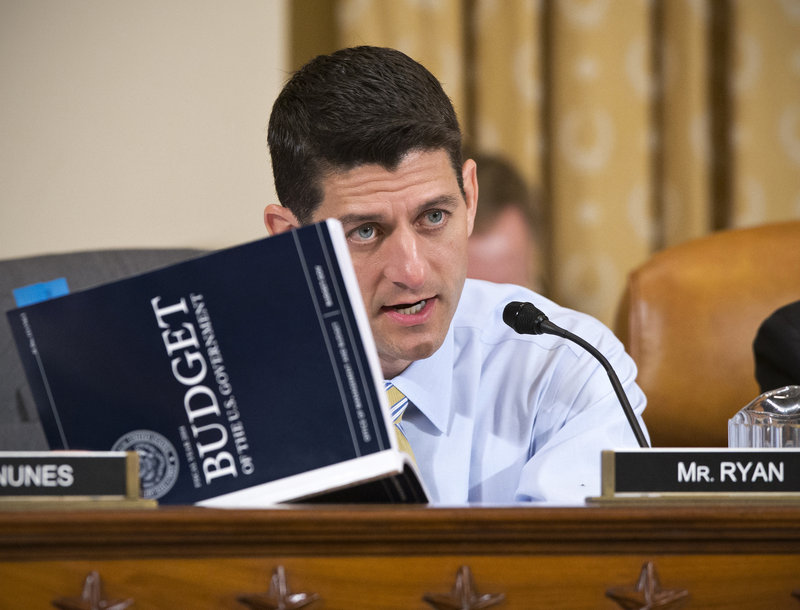 Rep. Paul Ryan, R-Wis., a member of the House Ways and Means Committee, holds a copy of the president’s fiscal 2014 budget proposal book during a hearing last week.