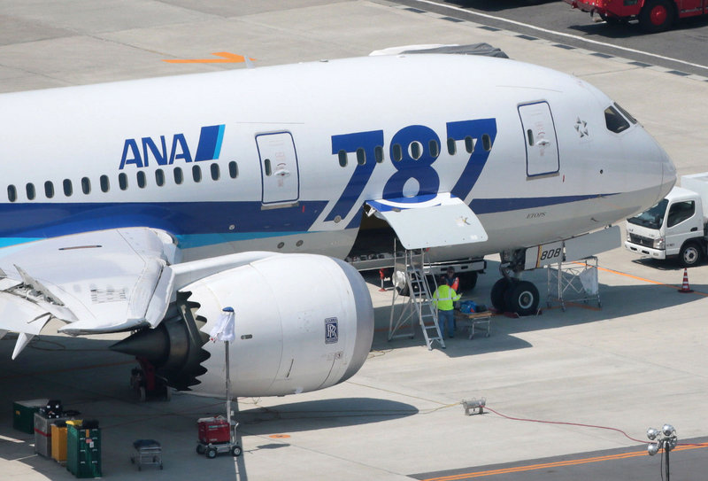 Modified batteries are put in a grounded All Nippon Airways Boeing 787 jet this week in Okayama, Japan.