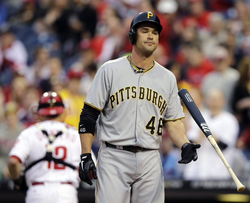 Garrett Jones of the Pirates throws his bat away in disgust after striking out against Roy Halladay of the Phillies in Wednesday night’s game at Philadelphia. The Pirates won, 5-3.