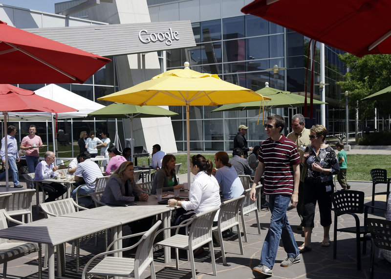 Employees and visitors congregate Thursday in a courtyard at Google headquarters in Mountain View, Calif. The company is under pressure in Europe to reduce antitrust concerns by changing the way it displays Internet search results.