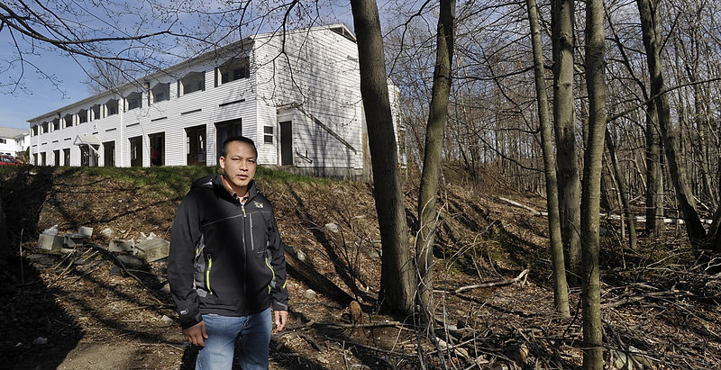 Tim Ly of MaineLy Property Management stands on the property owned by South Portland that he wants to buy.