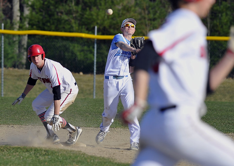 Brett Goodnow of Westbrook throws to first in an attempt to complete a double play Thursday after forcing Ben Greenberg of Scarborough at second base. Scarborough avoided the double play and went on to a 7-0 victory at Olmsted Field in Westbrook.