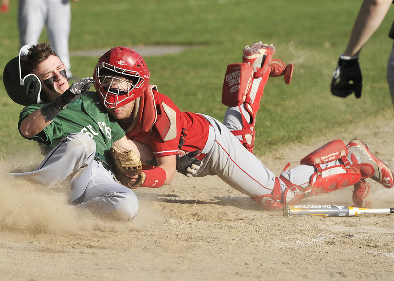 Corey Leach of Bonny Eagle, left, collides with Sanford catcher Ethan Gouin while attempting to score in the fifth inning Thursday during Bonny Eagle’s 8-2 victory at Standish. Leach, who drove in two runs in the game, scored when the ball got away.