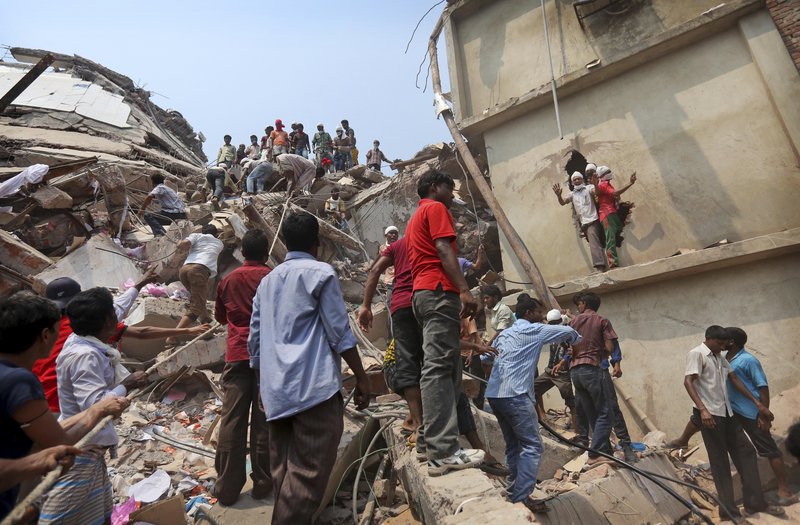 Bangladeshi rescuers work Friday at the site of a building that collapsed Wednesday in Savar, near Dhaka, Bangladesh.