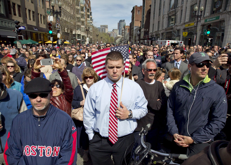 On Boston’s Boylston Street one week after the Boston Marathon bombings, a moment of silence is observed.