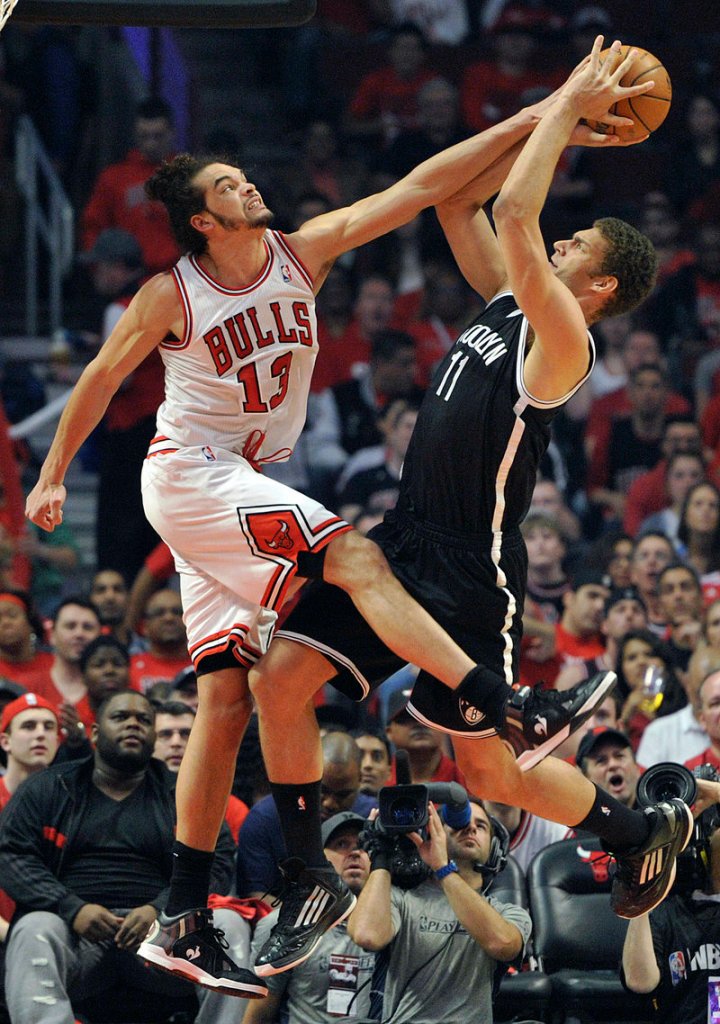 Joakim Noah of the Bulls blocks a shot by Brooklyn’s Brook Lopez during Game 4 of their first-round playoff series Saturday. Chicago leads 3-1 after a 142-134 triple-OT win.