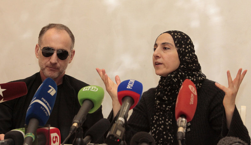 The mother of the two Boston bombing suspects, Zubeidat Tsarnaeva, speaks next to the suspects’ father, Anzor Tsarnaev, left, at a news conference Thursday. There are questions about how much Zubeidat Tsarnaeva knew about her sons’ plotting.