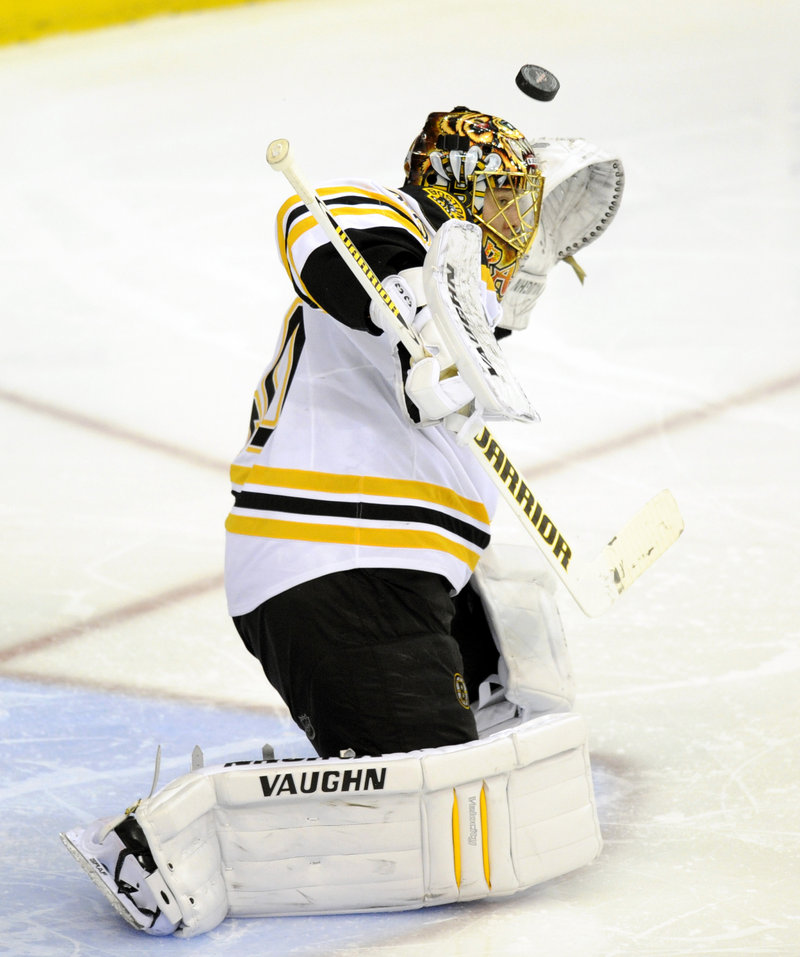 A shot sails over the glove of Bruins goalie Tuukka Rask during the third period of a 3-2 overtime loss Saturday.