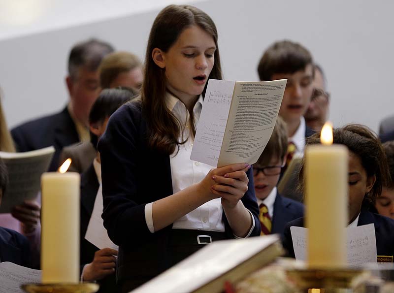 Annie Packard, 13, sings during Trinity Episcopal Church Sunday service at Temple Israel, which allowed the Trinity congregation to hold service in Boston. Trinity is within the blocked-off area near the finish line of the Boston Marathon, where earlier in the week two bombs exploded. Packard was in the grandstands when the first bomb exploded and ran away in the direction of the second bomb, which went off 10 seconds later.