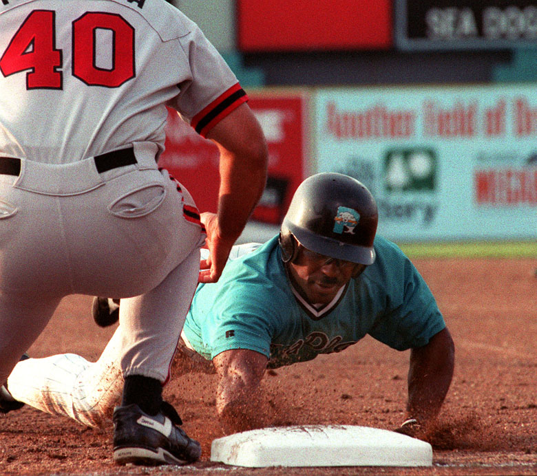 STAFF PHOTO BY JOHN PATRIQUIN -- Friday, August 16, 1996 -- Sea Dogs #11 Quinn Mack dives back to first safely to first against Harrisburg #40 Scott Talanoa during action at Hadlock Field. John Patriquin