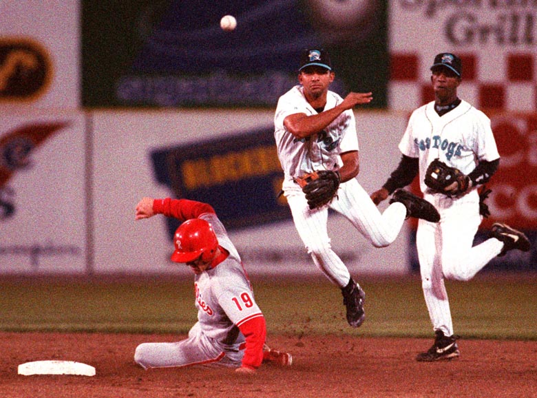 STAFF PHOTO BY DAVID MACDONALD -- Friday, August 30, 1996 -- Sea Dogs' shortstop Alex Gonzalez makes the relay to first base in an unsuccessful double play attempt in the third inning after making the force out on Reading Phillies' Scott Shores as Sea Dogs's second baseman Ralph Milliard watches. David MacDonald
