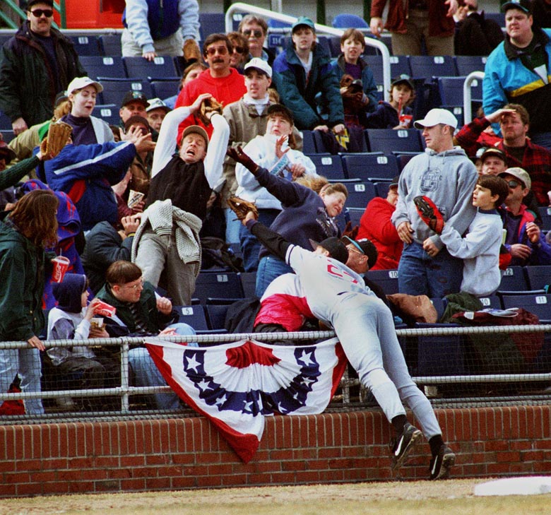 STAFF PHOTO BY DAVID MACDONALD -- Sunday, April 13, 1997 -- New Britain Rock Cats' third baseman Corey Koskie tries in vain to reach a third inning foul ball, a souvenir for a lucky fan. David MacDonald