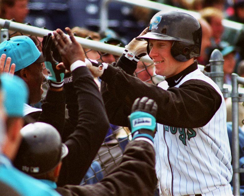 STAFF PHOTO BY DAVID MACDONALD -- Sunday, April 13, 1997 -- Mark Kotsay is congratulated by his team-mates after hitting a three run homer in the third inning, his third home run in two days. David MacDonald