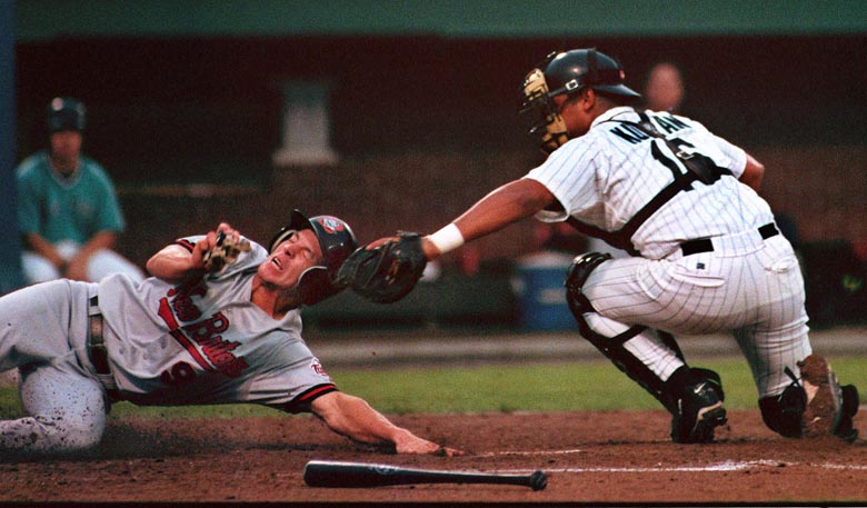 STAFF PHOTO BY JOHN PATRIQUIN -- Wednesday, June 24, 1998 -- New Britain #9 Chad Allen is tagged out at home by Sea Dogs catcher Hector Kuilan during action at Hadlock Field in Portland tonight.
