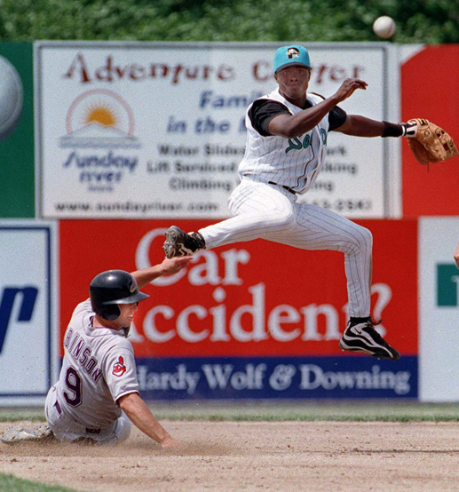 STAFF PHOTO BY HERB SWANSON -- Sunday, June 6, 1999 -- Pablo Ozuna fires to first base for a double play as Adam Robinson of the Akron Aeros turns to look after being forced out. Sea Dog early game action at Hadlock Field Herb Swanson