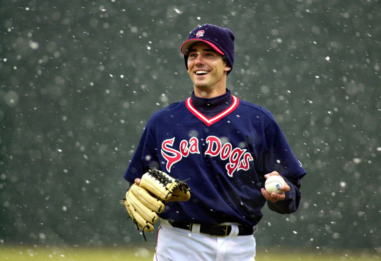 Portland Sea Dogs pitcher Greg Montalbano finds something to smile about while warming up in snow flurries at Hadlock Field before the season opener against the Trenton Thunder, Thursday, April 3, 2003, in Portland, Maine. The Sea Dogs are the new Double-A affiliate of the Boston Red Sox. (AP Photo/Robert F. Bukaty)