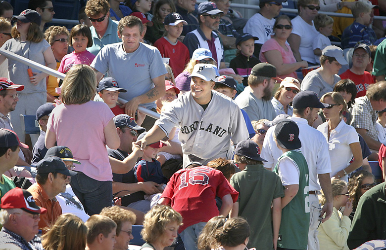 Tim Greenway/Staff Photographer: Sea Dogs catcher Juan Apodaca shakes hands with fans before the annual Field of Dreams game at Hadlock Field. The Sea Dogs wore uniforms from the Portland Eskimos of the 1920s, and walked through the stands to thank fans for their support. Baseball