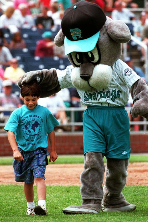 STAFF PHOTO BY JOHN EWING -- Thursday, July 17, 1997 -- Slugger, the Portland Sea Dogs mascot, congratulates Alan Meserve, of Ossipee, N.H., for winning a between inning race around the bases at a recent game at Hadlock Field. John Ewing