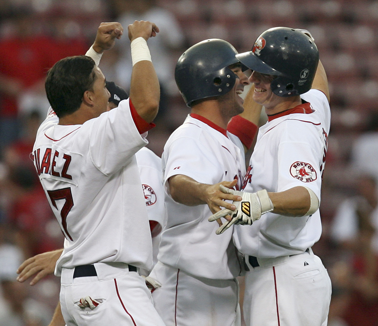 SPECIAL TO THE PORTLAND PRESS HERALD: Portland Sea Dogs Jay Johnson, right, is congratulated by teammates after knocking in the game winning run in the bottom of the ninth inning during the Futures at Fenway baseball game against the Harrisburg Senators, Saturday, Aug. 11, 2007 at Fenway park in Boston. (AP Photo/Mary Schwalm) Baseball
