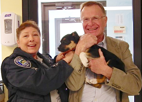 Sanford Animal Control Officer Lauren Masellas and Animal Welfare Society Executive Director Steve Jacobsen welcome Walton back to the shelter in West Kennebunk.