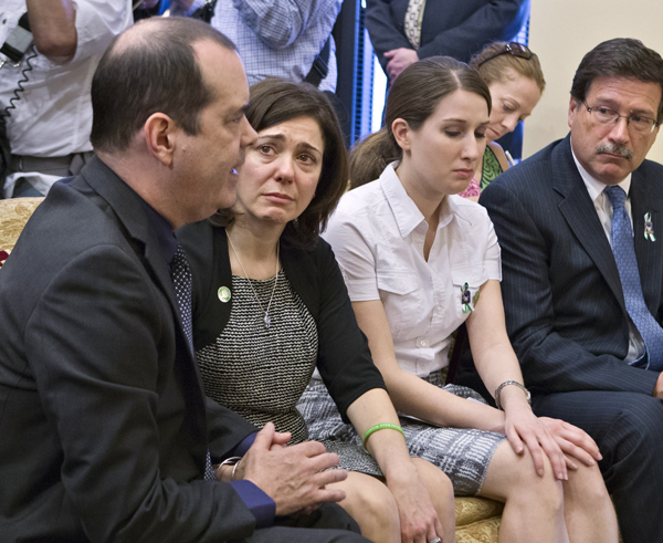 Families of victims of the Sandy Hook Elementary School shooting meet with Sen. Joe Manchin, D-W.Va., after he announced a bipartisan deal on expanding background checks on Capitol Hill on Wednesday. David and Francine Wheeler are at left.