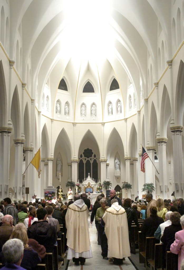In this April 2005 file photo, communion at Portland's Cathedral of the Immaculate Conception, the seat of the Roman Catholic Diocese of Portland. during a mass Monday evening for Pope John Paul II. Two brothers who served as altar boys in the 1970s are suing the Roman Catholic Diocese of Portland, claiming diocese officials knew the Rev. James Vallely was sexually abusing them and other young children but failed to stop it. Doug Jones