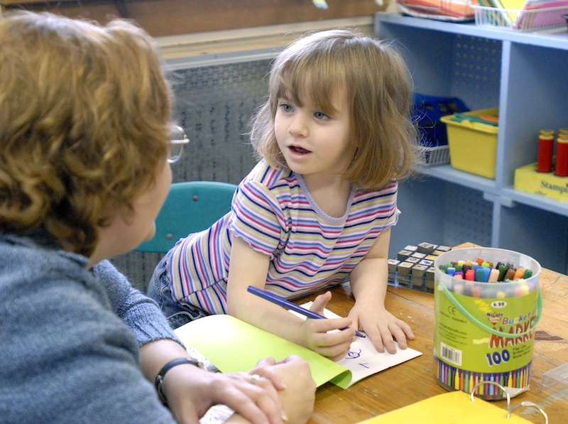 In this December 2007 file photo, teacher Anne Sprague works with 4-year-old Trinity Ramsay and other preschoolers in a reading class at St. Elizabeth's Children Center in Portland. Business leaders and children's advocates gathered at the State House on Wednesday to urge state officials to make a greater investment in early childhood education programs, citing a new report that details the benefits.