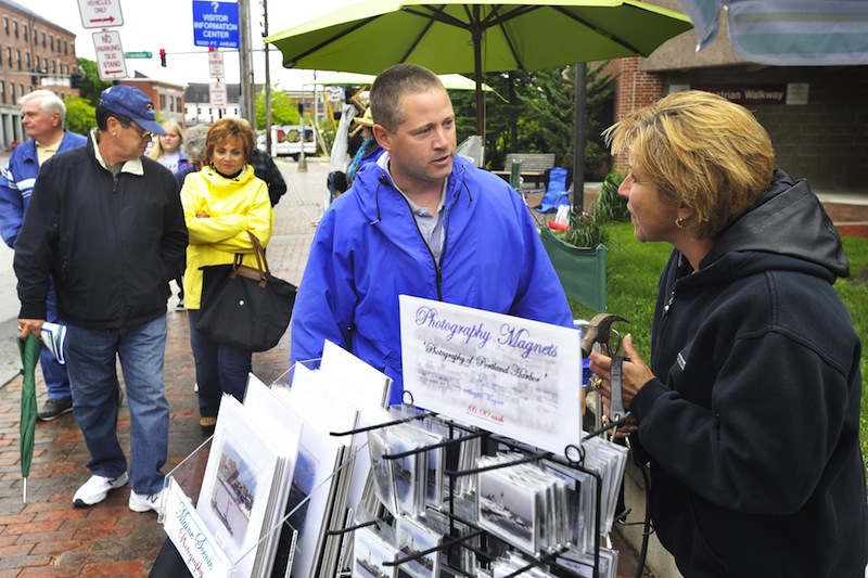 In this June 2012 file photo, Portland code enforcement officer Chuck Fagone talks with Tara Michaud about regulations for street vendors using city sidewalks. fter two years of debate, the City Council has backed off an effort to require street art sellers to register with the city, passing only modest new restrictions for street artists.