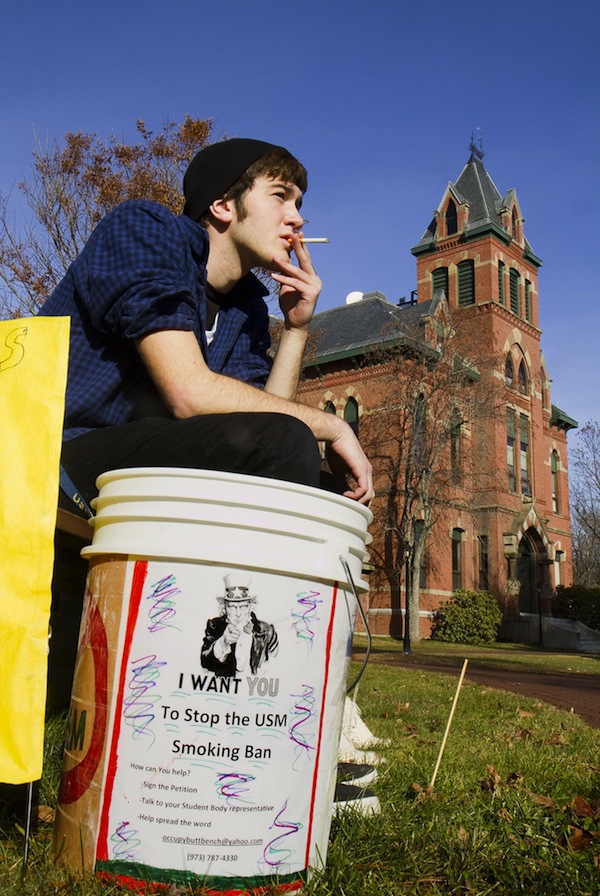 In this December 2012 file photo, USM freshman Joshua Thornberg smokes at the USM-Gorham campus during a protest of a proposed smoking ban on USM campuses.