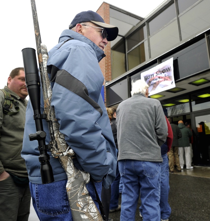 In this January 19, 2013 file photo, Sid Strom from Norway, ME waits for the opening for the Augusta Gun Show at the Augusta Civic Center. The Maine Senate voted 19-16 on Thursday, May 30, 2013 to defeat a bill that would require background checks for all firearms sales at gun shows, a major loophole that allows violent offenders to easily get their hands on weapons, gun-control advocates say.