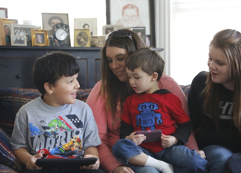 Ja'kai Hayden, 8, left, spends time with his brother Javanni, 3, and cousins Courtney Courtemanche, 22, of Somersworth, NH and Brooke Spence, 11, right, of Dover, NH, on Saturday, March 9, 2013 during a family gathering in Portland.