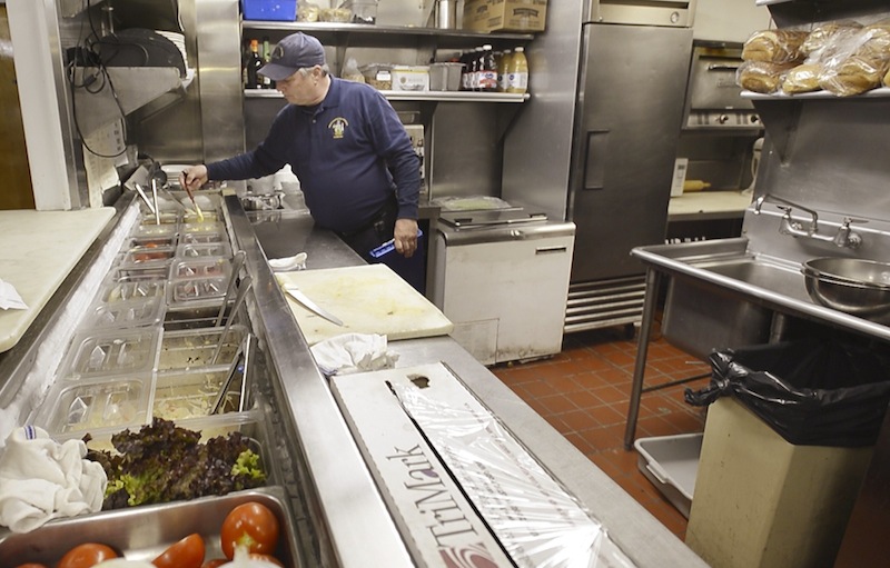 Scott Davis, a health inspector with the state of Maine, looks over a food prep area in the kitchen at the Stage Neck Inn in York during an inspection on Thursday, March 14, 2013.