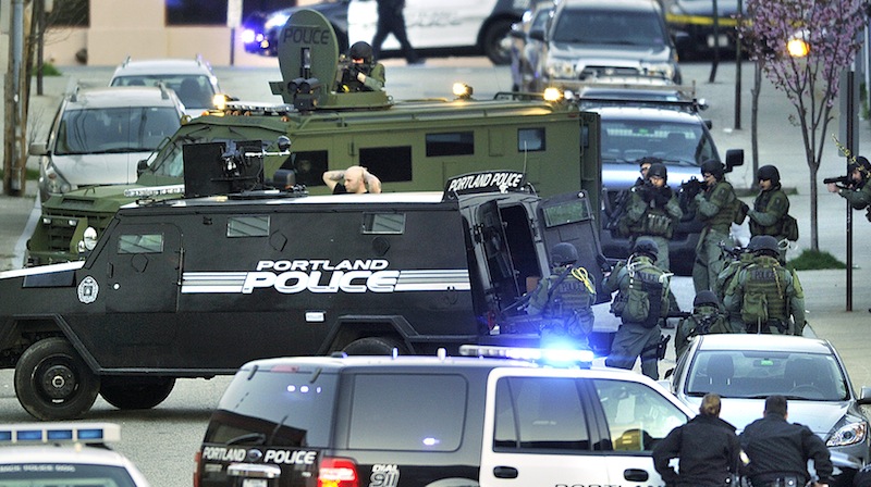 Kyle Upton surrenders – surrounded by Portland police and SWAT Team members – after a standoff on Alder Street in Portland on April 29, 2013.