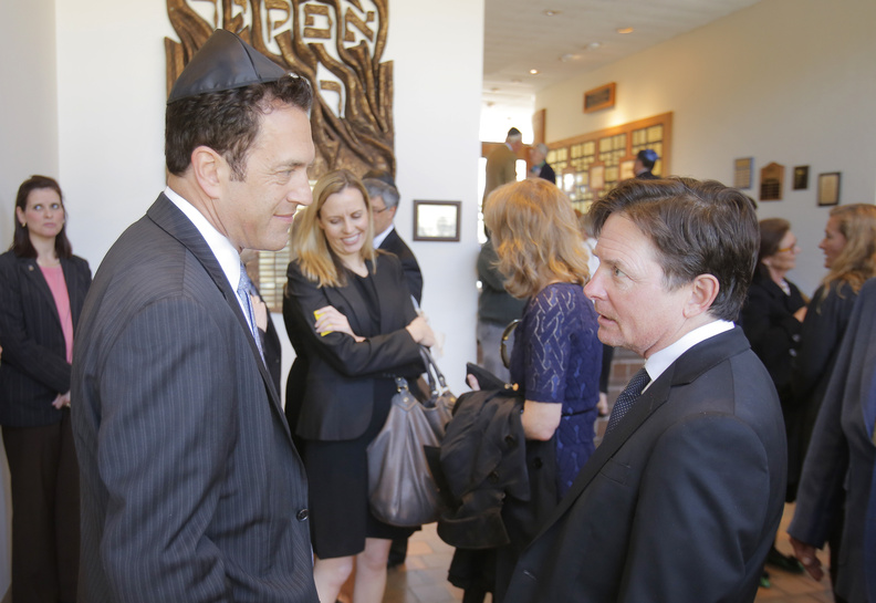 David Glickman, left, son of Albert Glickman, talks with actor Michael J. Fox after the funeral for Albert Glickman at Temple Beth El in Portland on Wednesday. Albert Glickman, who passed away on April 27, was on the board of the Michael J. Fox Foundation for Parkinson's Research.